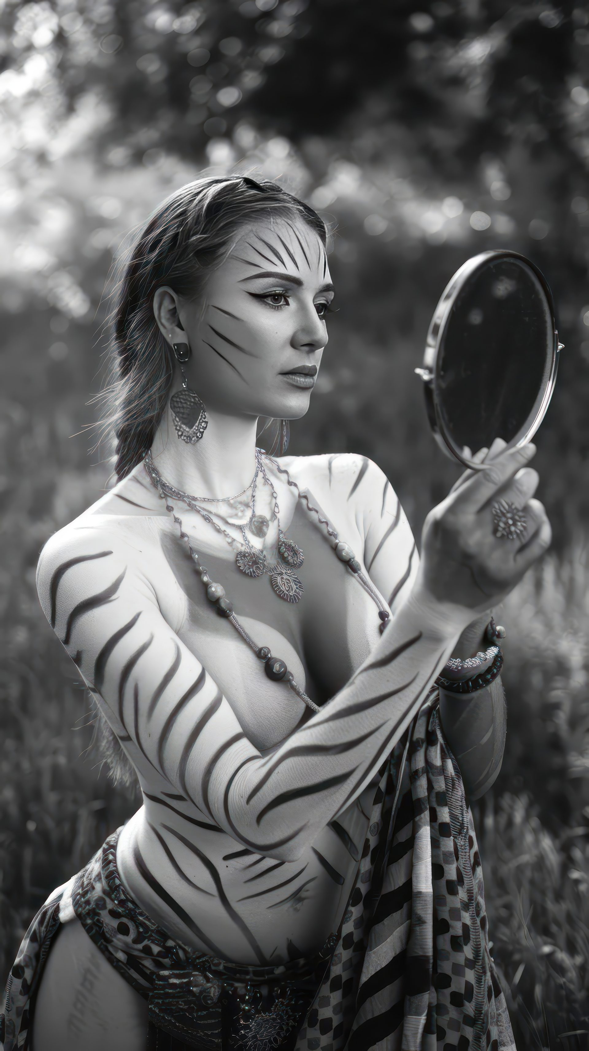black-and-white-wild-woman-female-in-tiger-style-holding-mirror-in-jungle